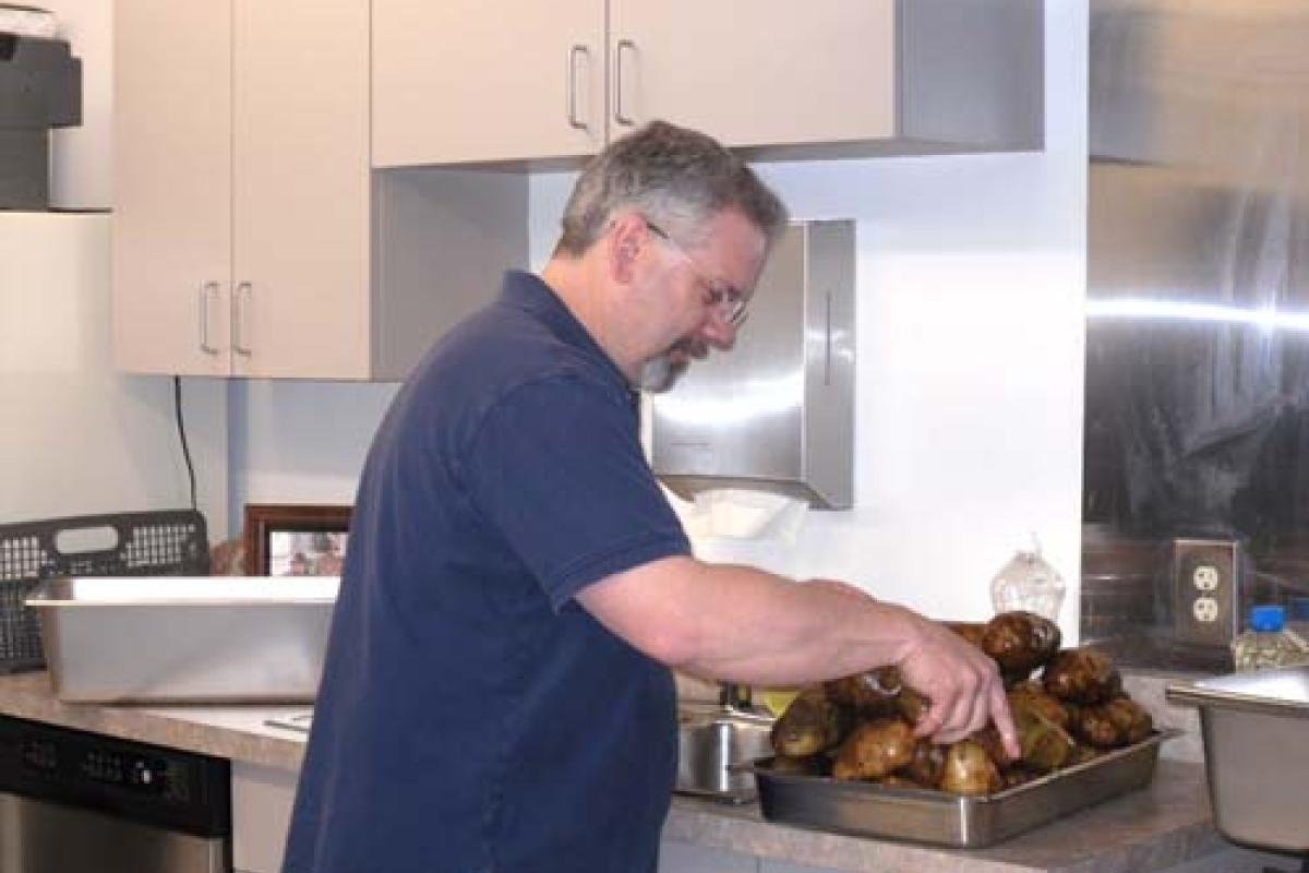Man washing potatoes