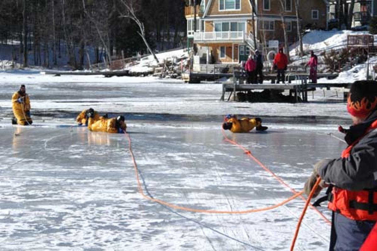 People being rescued from frozen lake