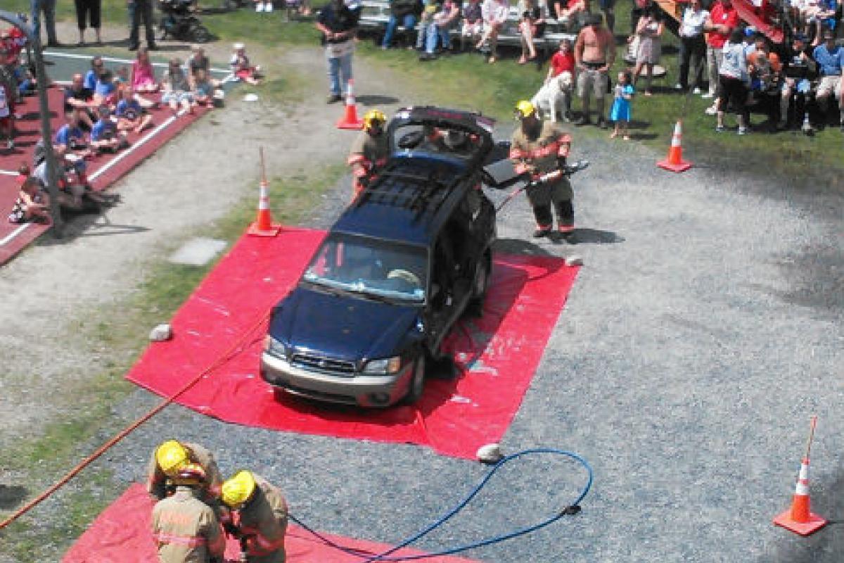 Firemen taking apart a car