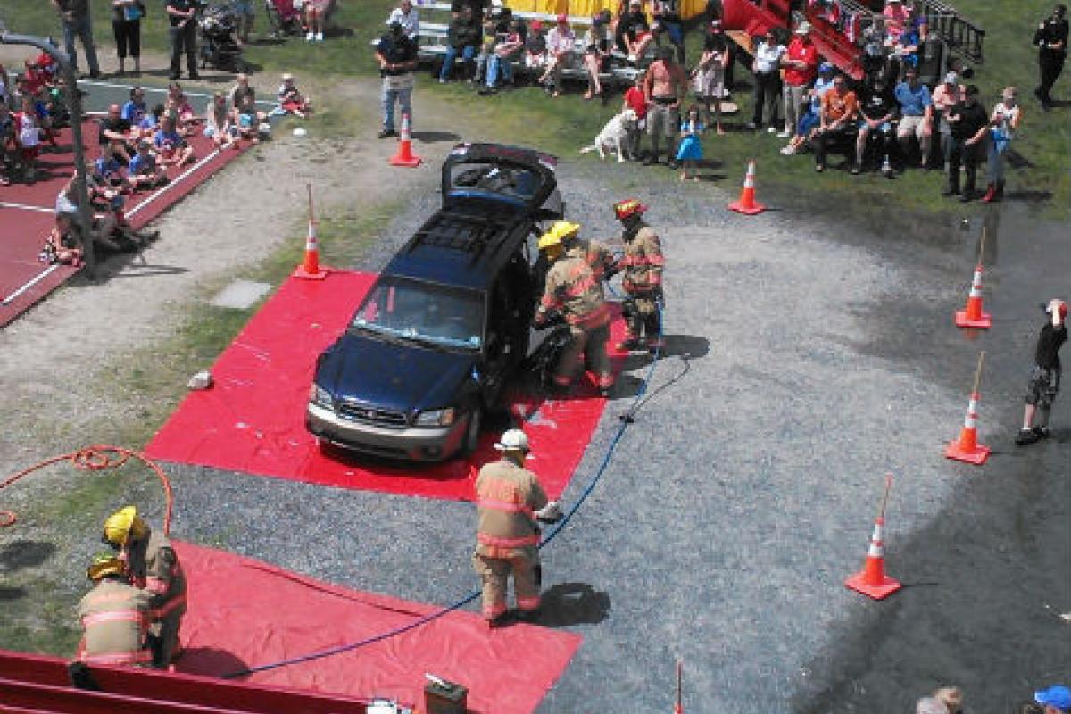 Firemen taking apart a car