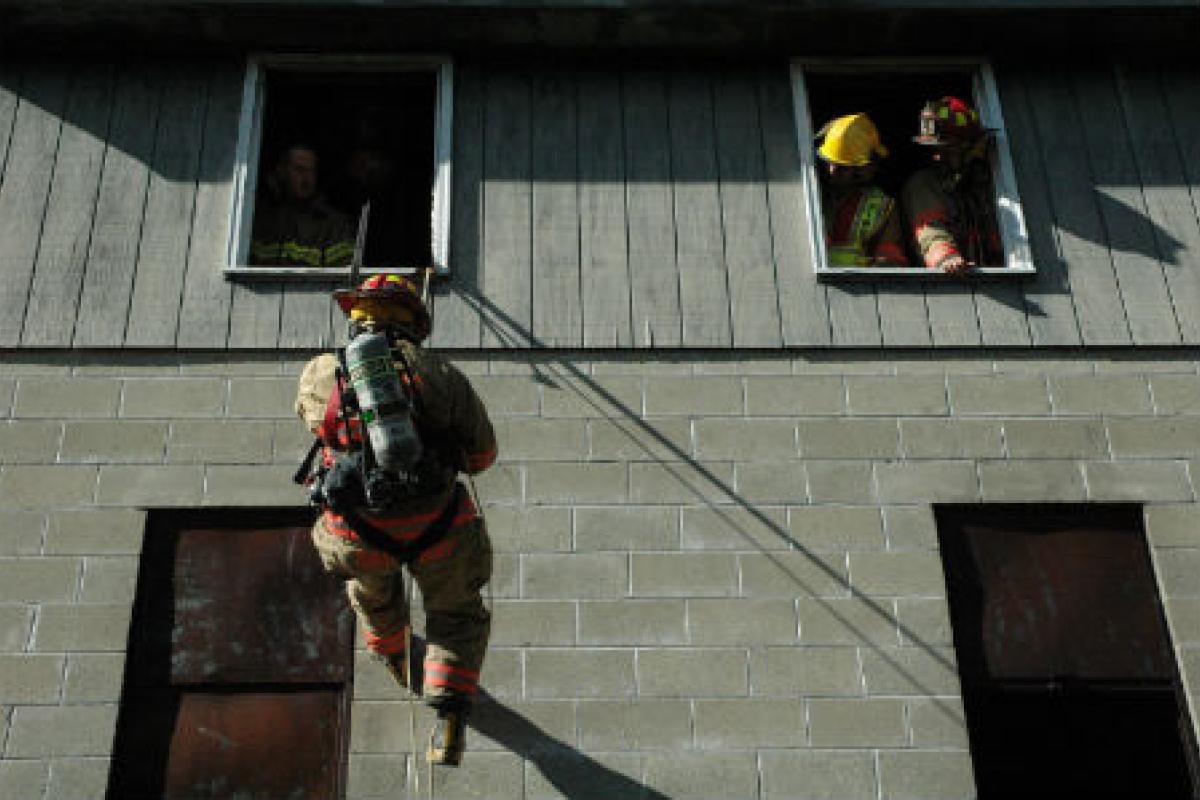 Fireman climbing out a window