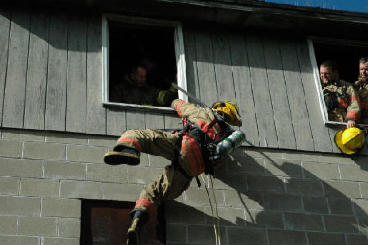 Fireman climbing out a window