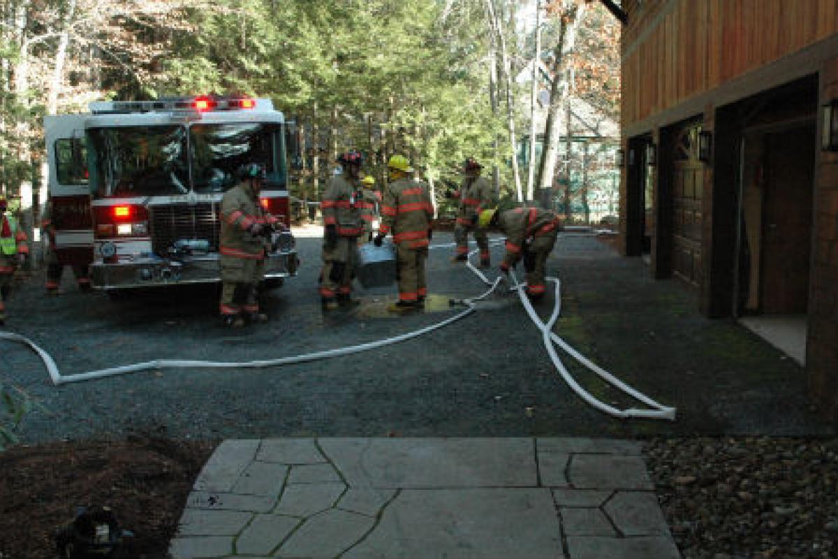 firefighters moving a hose